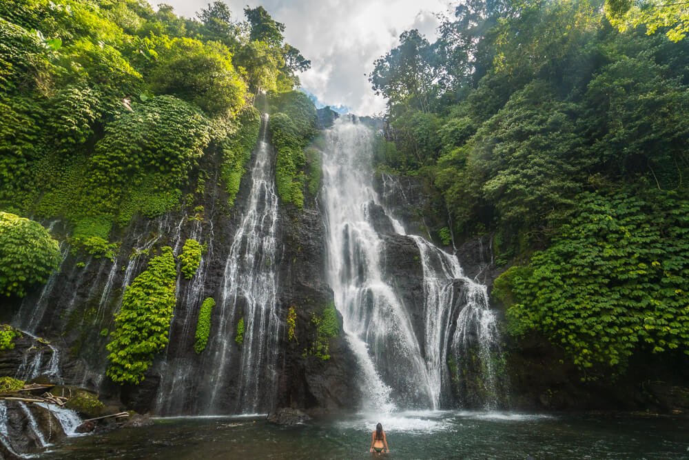 Beautiful twin waterfalls with a natural swimming pool in the jungle of Northern Bali.