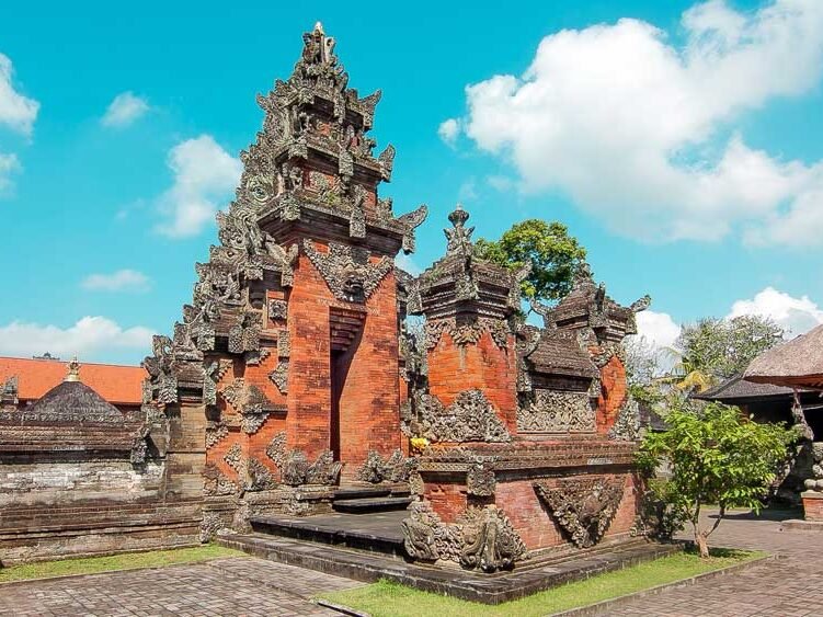 Detailed sandstone carvings and ancient architecture of Pura Puseh Batuan, a historic Balinese village temple.