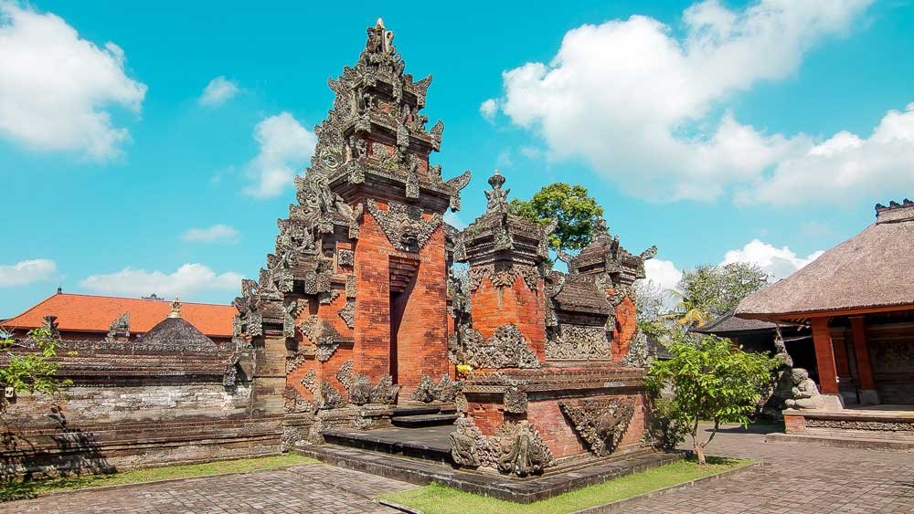 Detailed sandstone carvings and ancient architecture of Pura Puseh Batuan, a historic Balinese village temple.