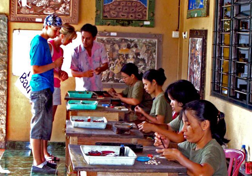 Master craftsman making intricate silver jewelry at Celuk Village, an authentic Ubud arts village.
