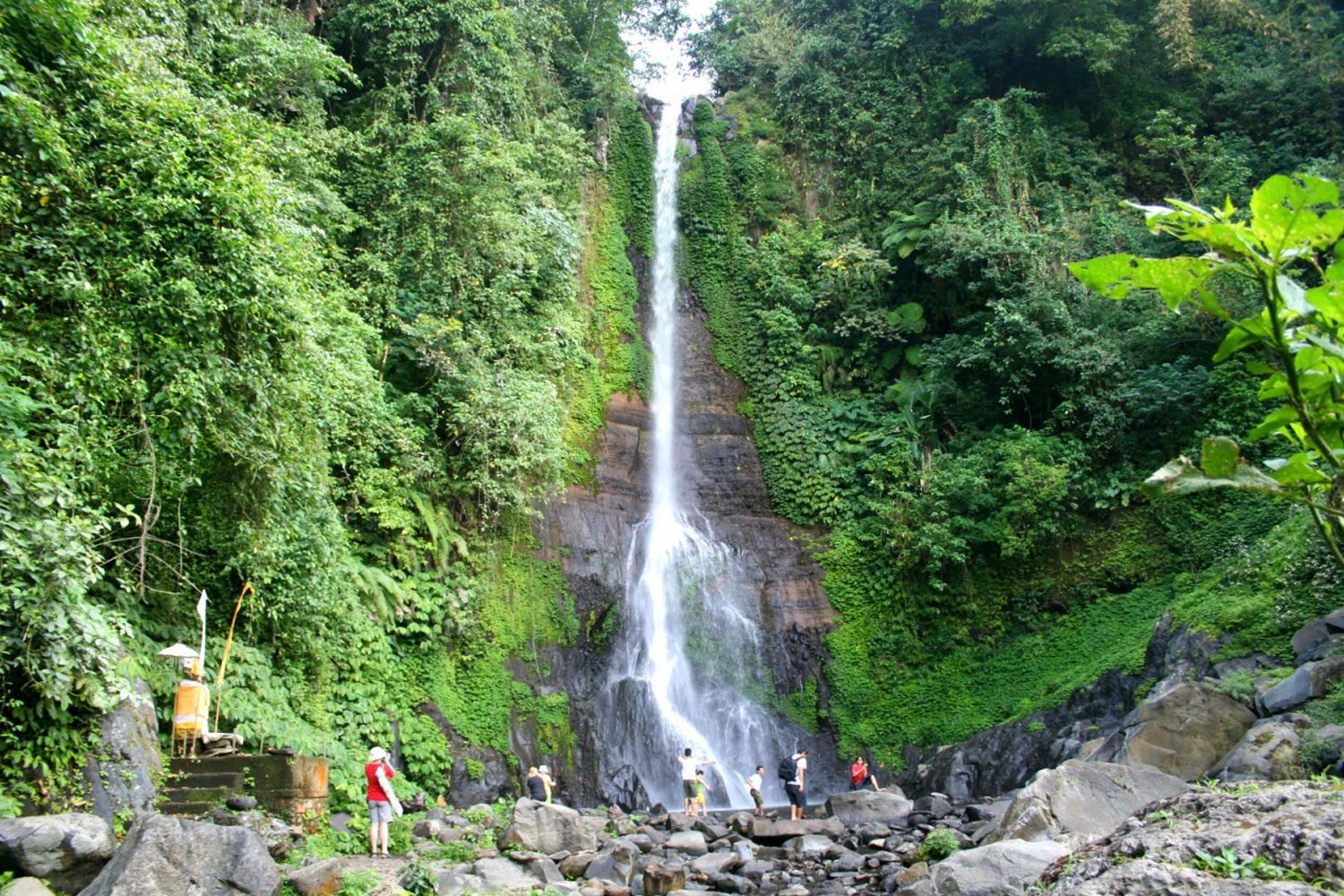 The majestic Gitgit Waterfall surrounded by tropical trees in North Bali.