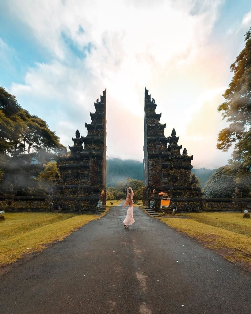 The majestic stone entrance gate of Bali Handara with mountain views.